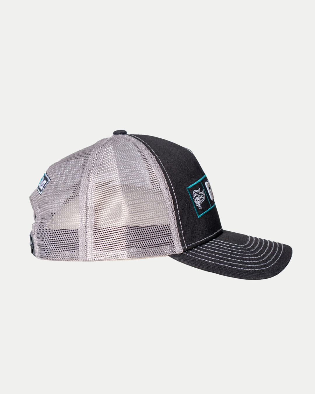 The 25-26 CCM Trucker Cap from Belfast Giants Store by National Merchandise is a black and white hat with a mesh back, solid front panel, and a rectangular embroidered side patch. Shown in side profile on a white background.