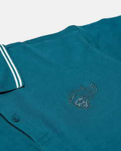 The Belfast Giants Teal Polo Shirt by Belfast Giants features white-striped collar details and an embroidered flame logo on the chest, displayed flat on a white background.