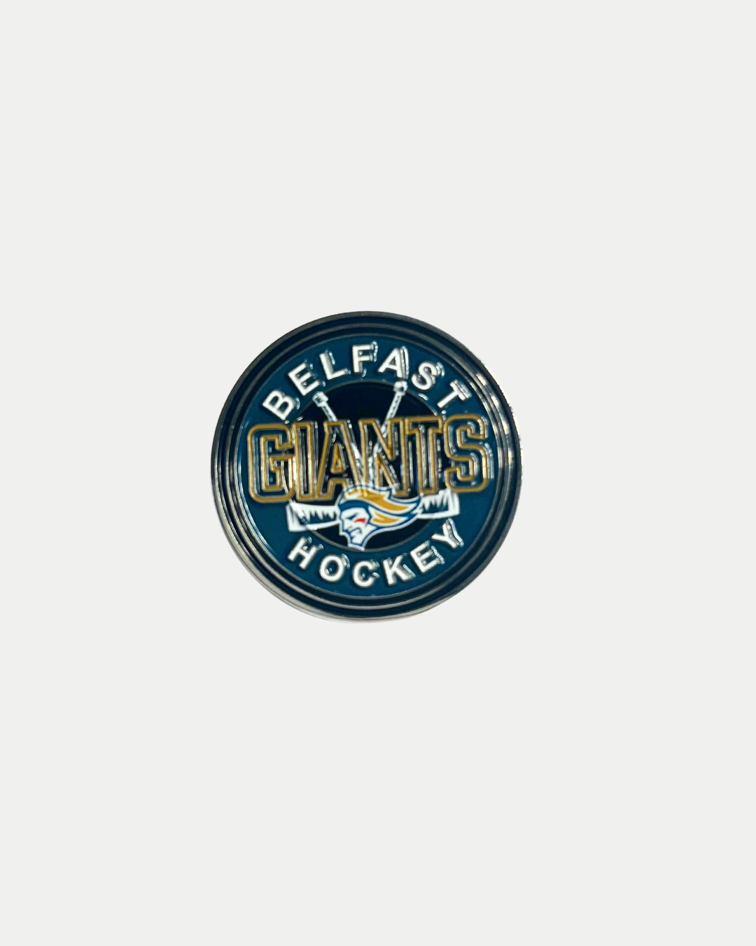 The Belfast Giants Pin Badge Sticks 25/26 from the Belfast Giants Store by National Merchandise features the team logo with crossed hockey sticks and a fierce giant head, plus bold “Belfast Giants Hockey” lettering on a dark background.