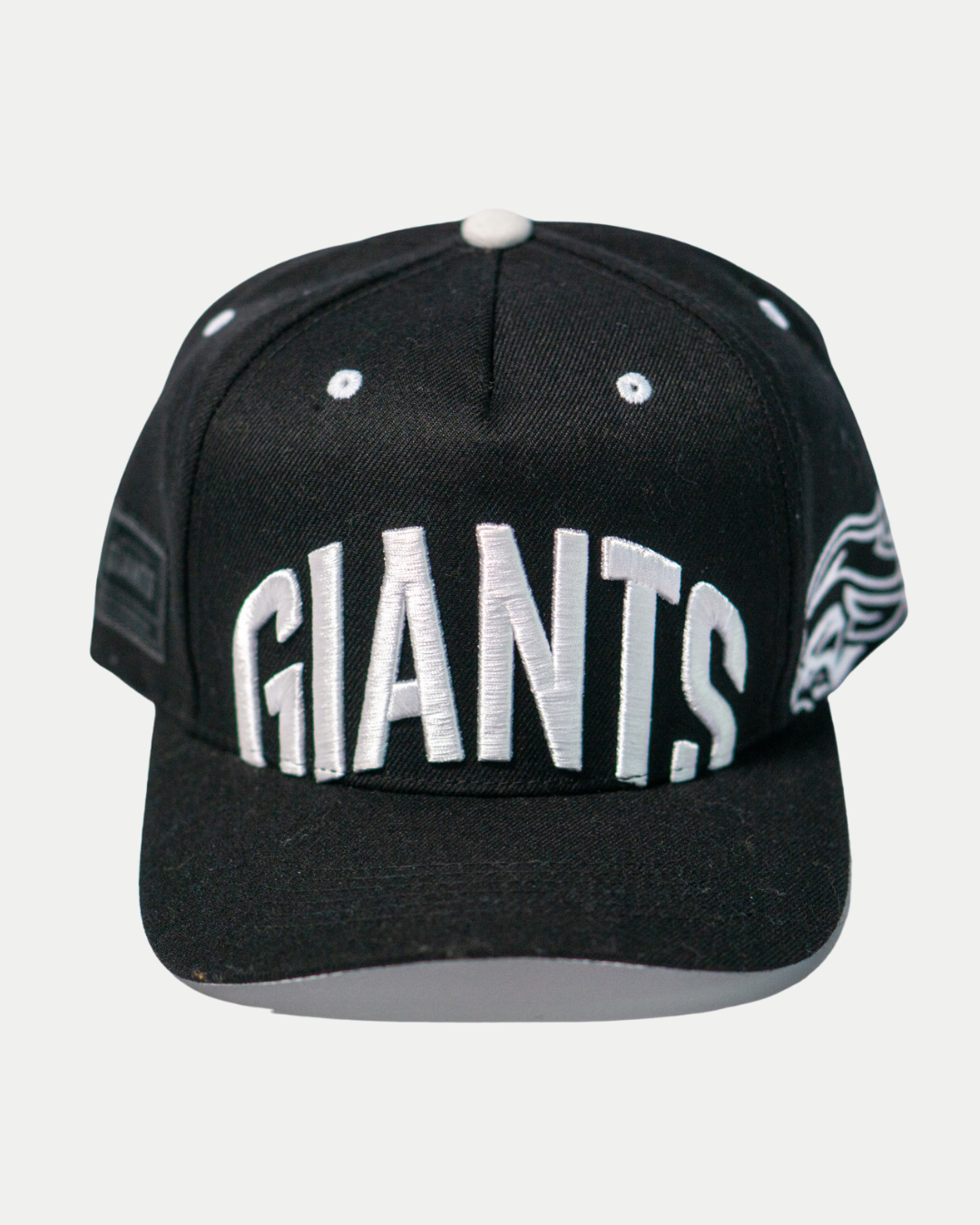 The Belfast Giants Cap Black and White by Belfast Giants features bold white front embroidery, a white top button, and matching eyelets—a must-have classic for any fan.
