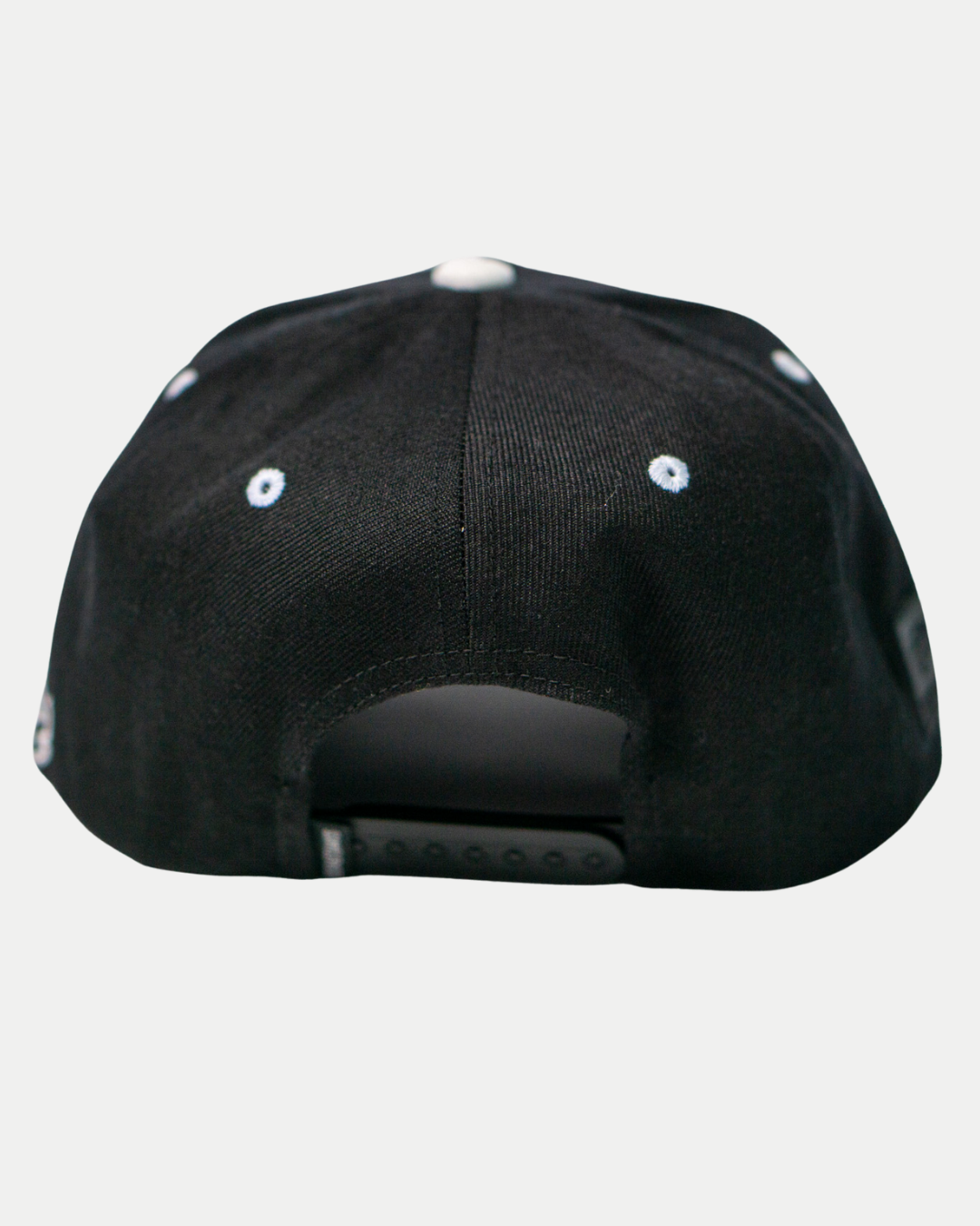 The Belfast Giants Cap Black and White by Belfast Giants features an adjustable snapback closure and small white embroidered eyelets on the panels—a true supporter staple, seen here from the back.