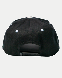 The Belfast Giants Cap Black and White by Belfast Giants features an adjustable snapback closure and small white embroidered eyelets on the panels—a true supporter staple, seen here from the back.