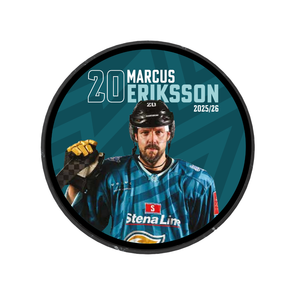 The 2025-26 Player Puck by Belfast Giants is a limited edition ice hockey puck featuring Marcus Eriksson in a blue jersey with Stena Line, holding a hockey stick, and "20 Marcus Eriksson 2025/26" printed on it.