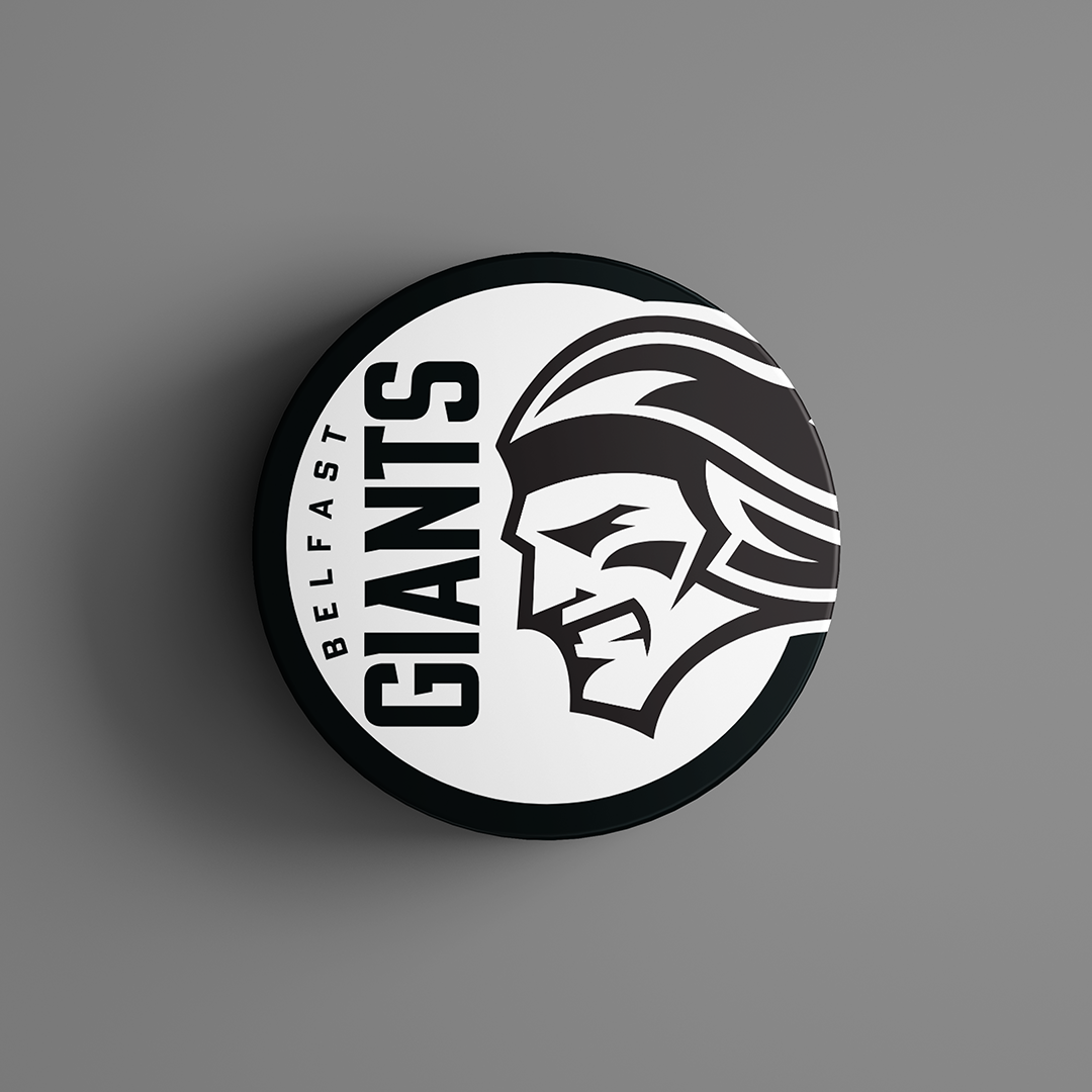 The Belfast Giants Black Logo Puck 25-26 from Belfast Giants Store by National Merchandise features a black puck with the team’s stylized giant face logo in profile and bold Belfast Giants text on a white background.
