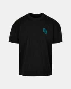 The BG Logo Black Oversized T-Shirt by Belfast Giants is a plain black short-sleeve tee with a subtle teal BG logo on the left chest, shown against a clean white background.
