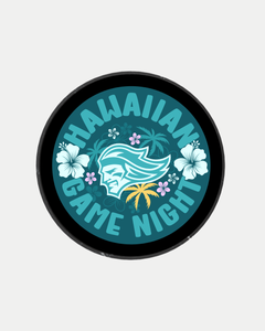 The Belfast Giants Hawaiian Night Puck from Belfast Giants Store by National Merchandise features a round logo with "Hawaiian Game Night" text, a white stylized face with long hair, hibiscus flowers, leaves, and palm trees on a teal background.